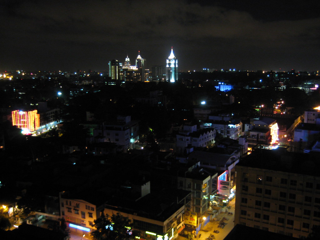 Bangalore at night, the lit towers of UB City on the skyline. Photograph by Melanie-m on Flickr.